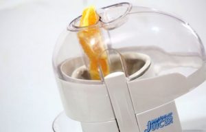 Cho cam vào máy ép lấy nước